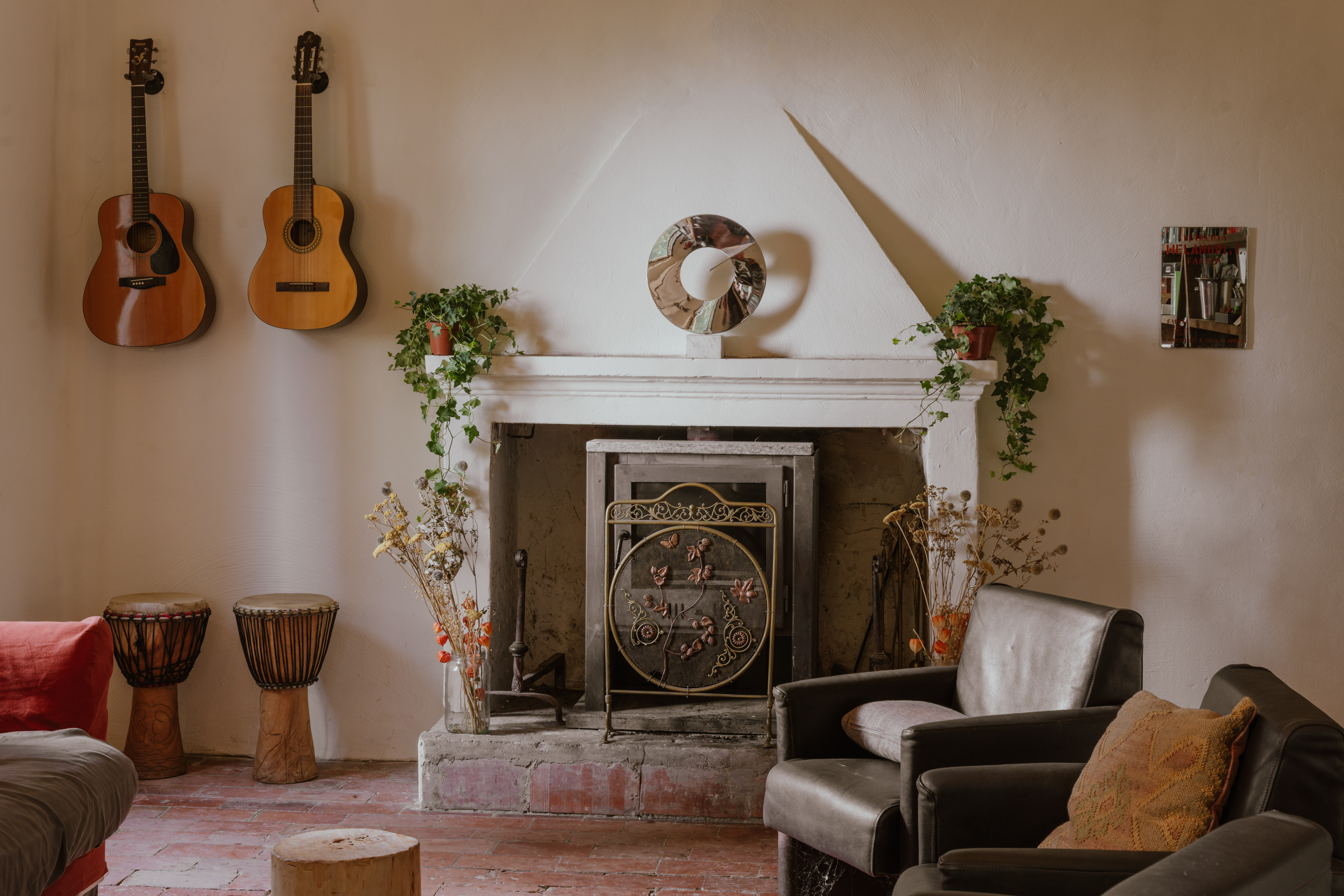 The living room with fireplace, guitars and djembe drums