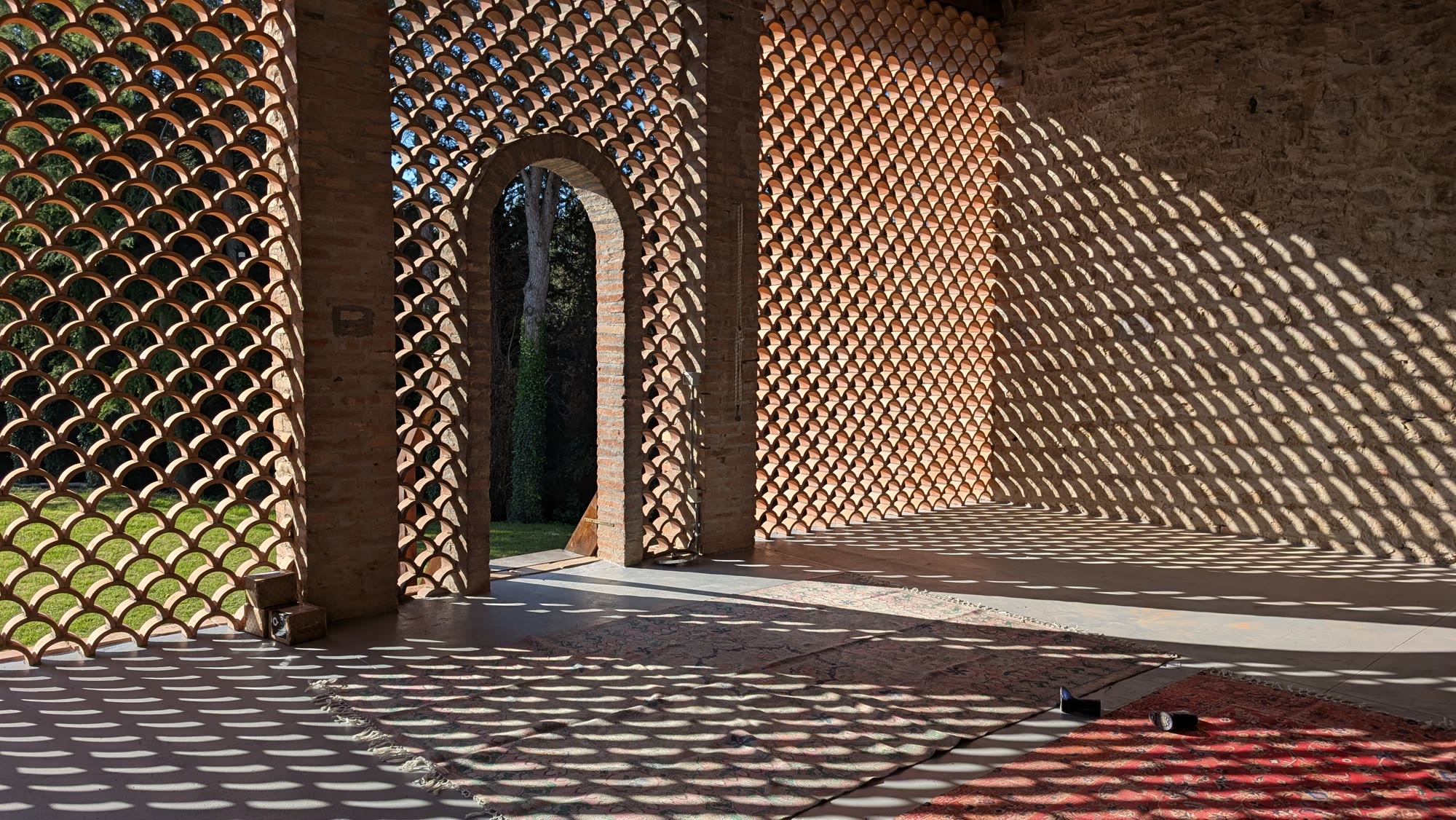 Afternoon light through the terracotta 'frangisole' wall of the studio